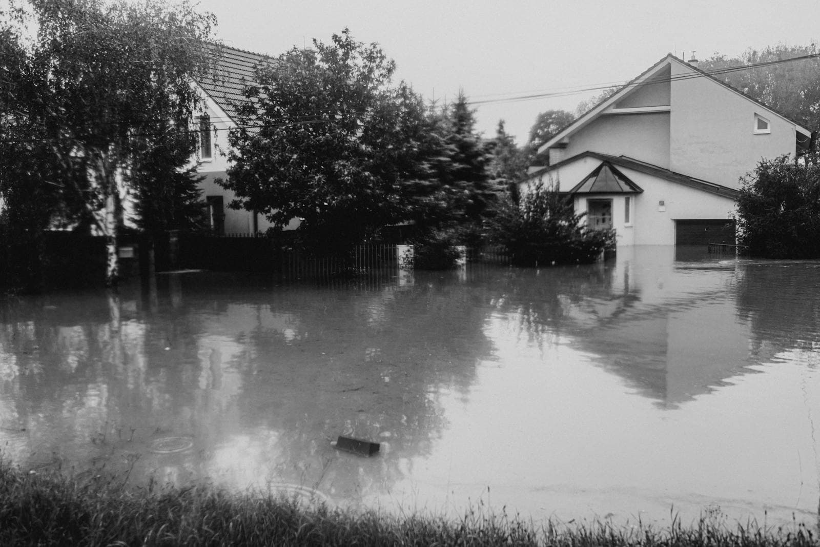 Flooded residential street showing water damage